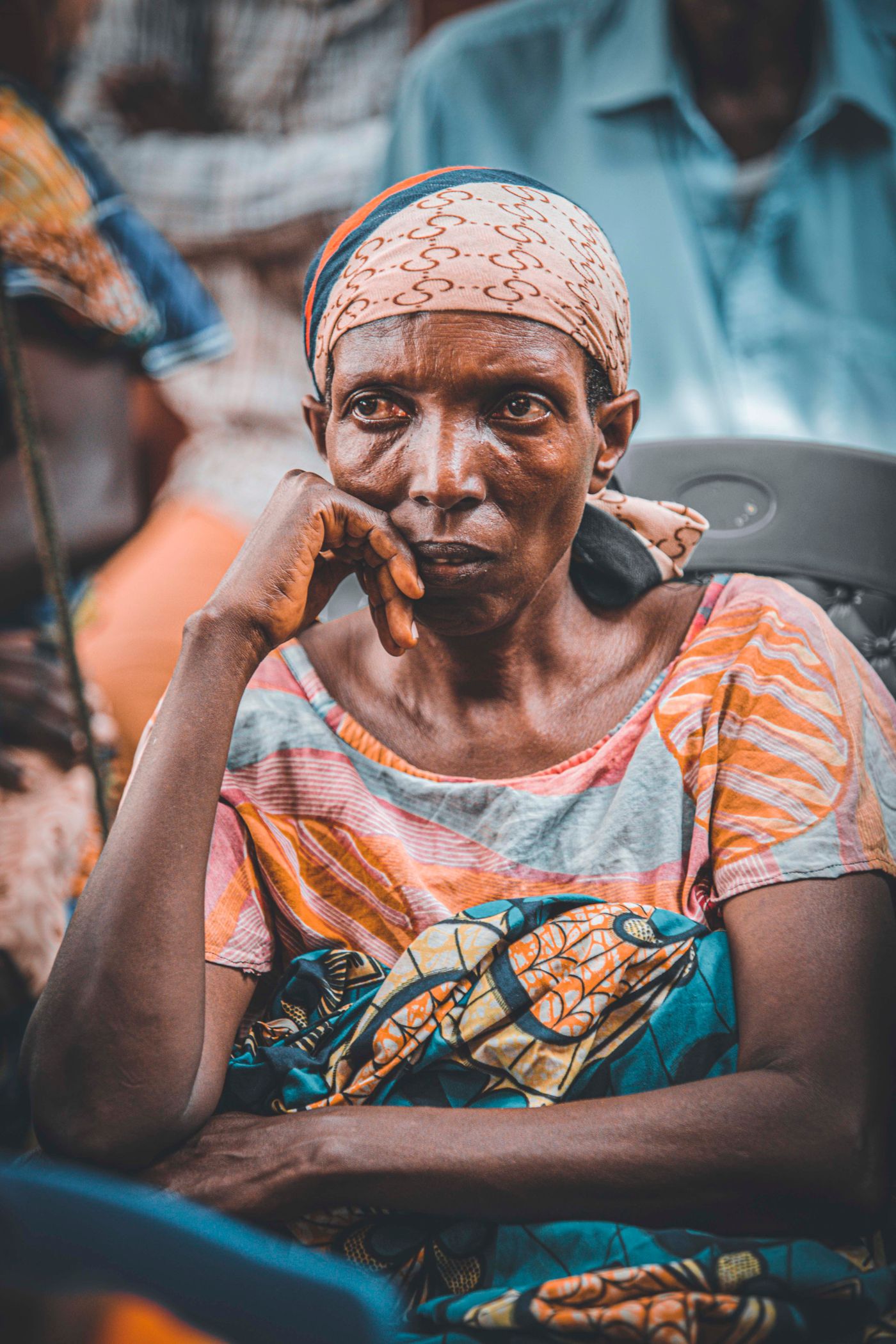 A woman seated in thought, conveying quiet strength